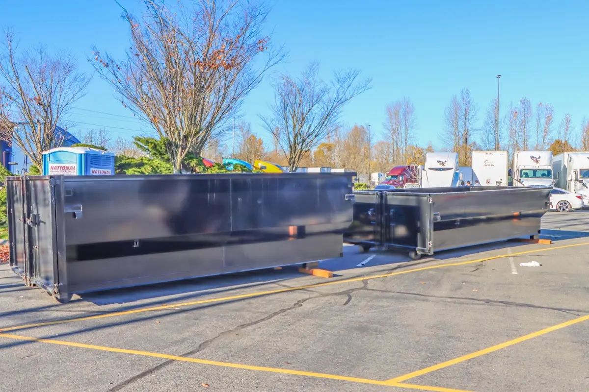 Professional dumpster rental service with roll-off container on residential driveway in Prospect Park